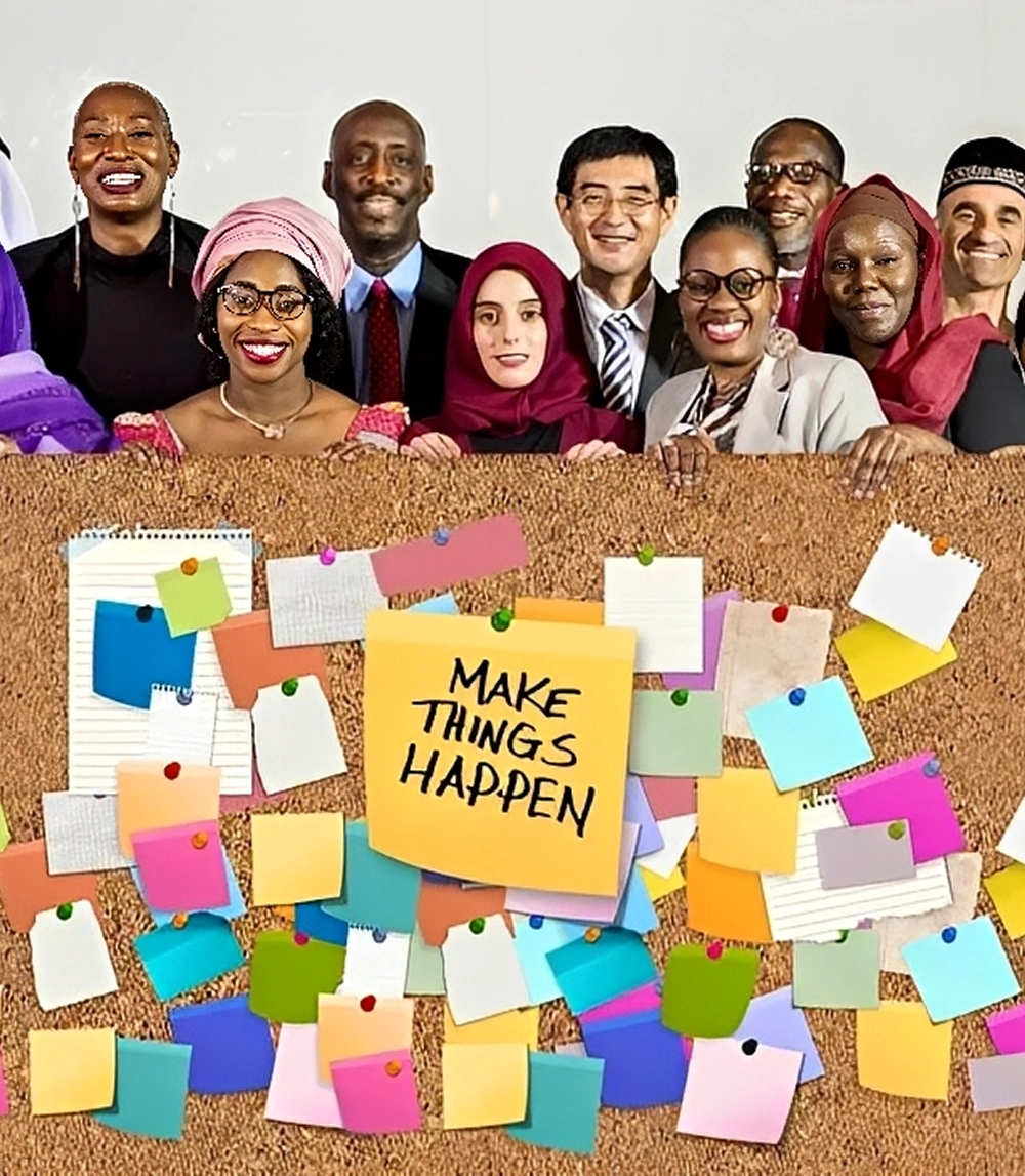 Diverse group behind "Make Things Happen" board.