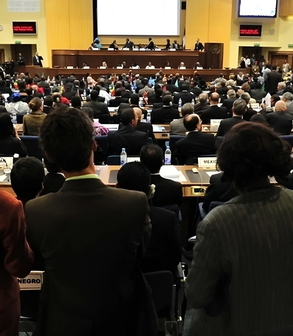 Large conference with attendees and speakers on stage.